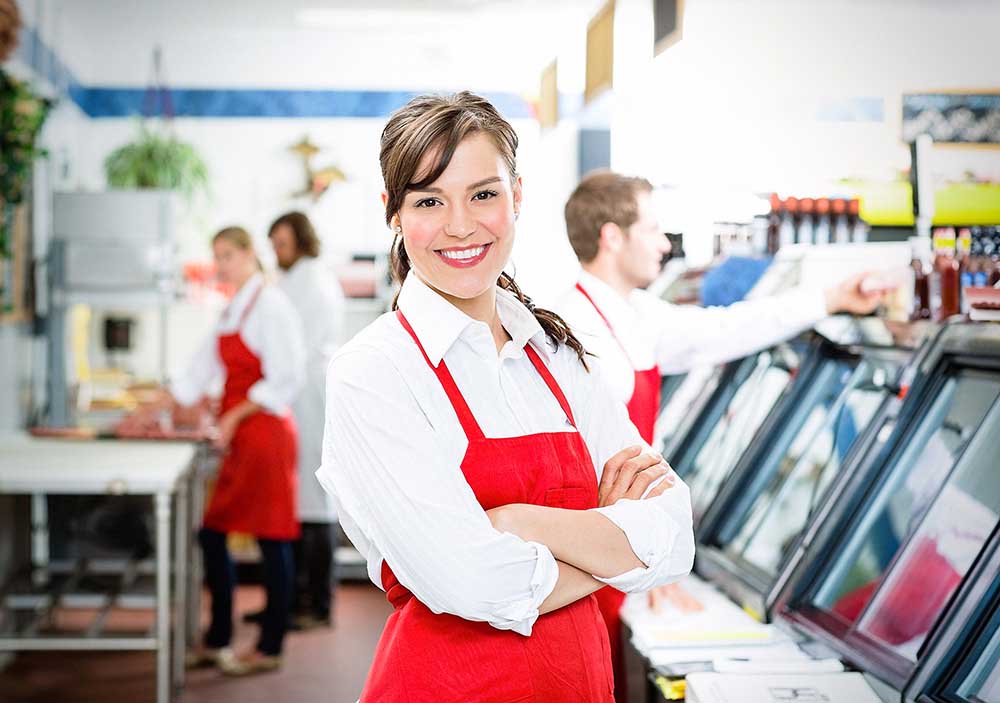 smiling woman working in a grocery store